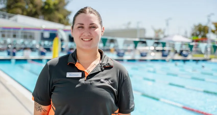 Montanah MARC staff member standing in front of a pool 